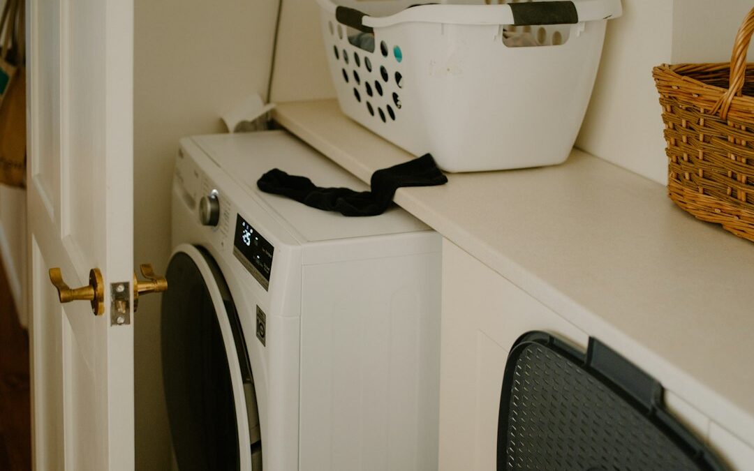 White washing machine with a laundry basket - how to stay on top of laundry